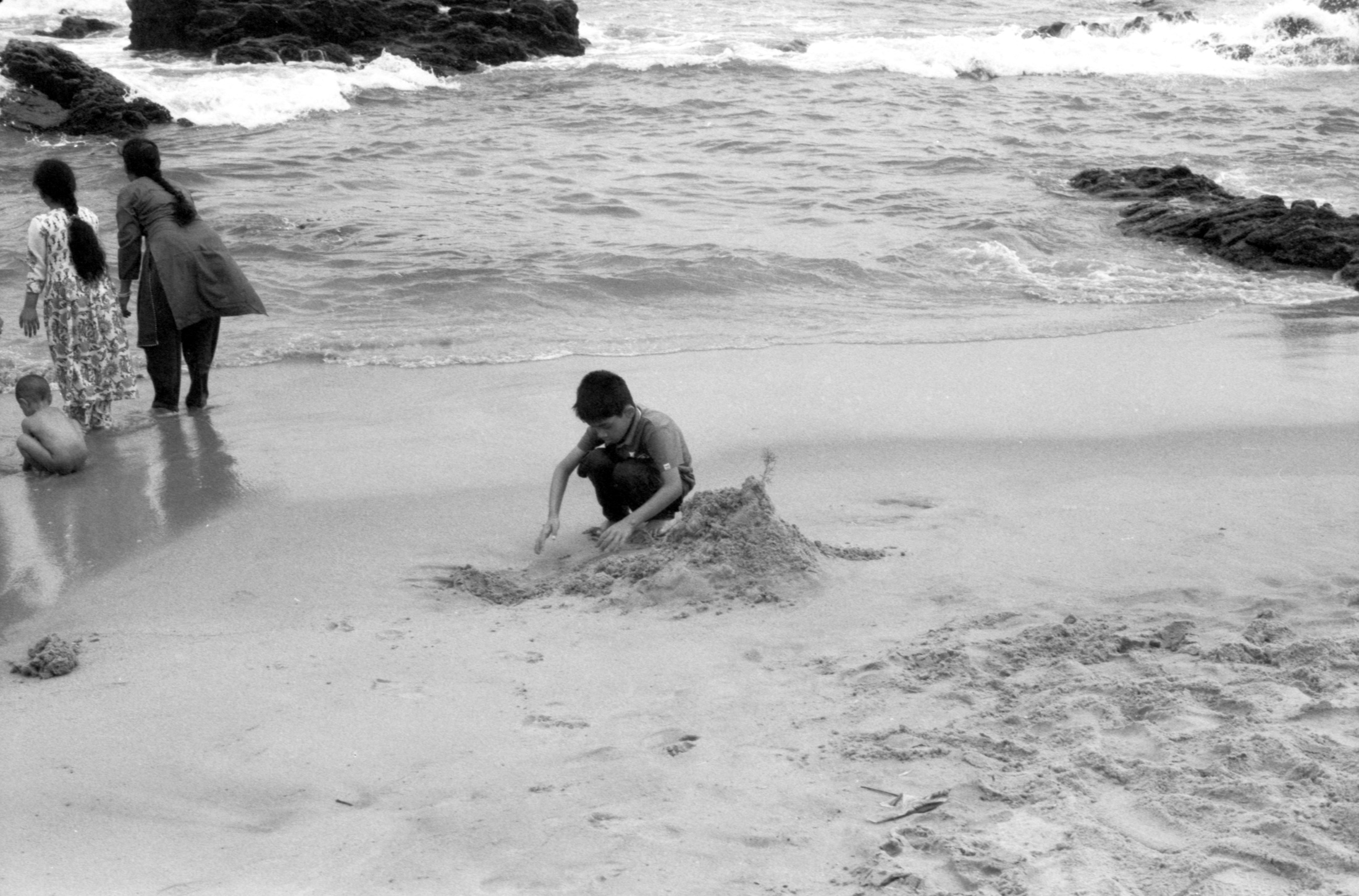 Kid Building Sand Castle